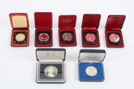 A collection of seven cased silver and white metal collectors souvenir coins, from Canada, mostly