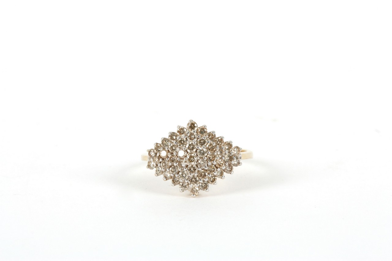 A 9ct gold oval diamond cluster ring, Modern, set with numerous small diamonds In good overall