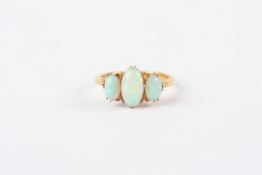 A 19th century gold coloured metal and opal ring, set with three oval opals, in claw setting In very