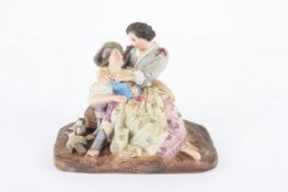 A German Sitzendorf porcelain group of a courting couple, resplendent in 18th century dress, in an