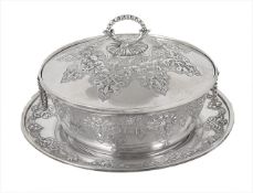 A Victorian silver muffin dish with cover and saucer, hallmarked London 1892, with repoussé