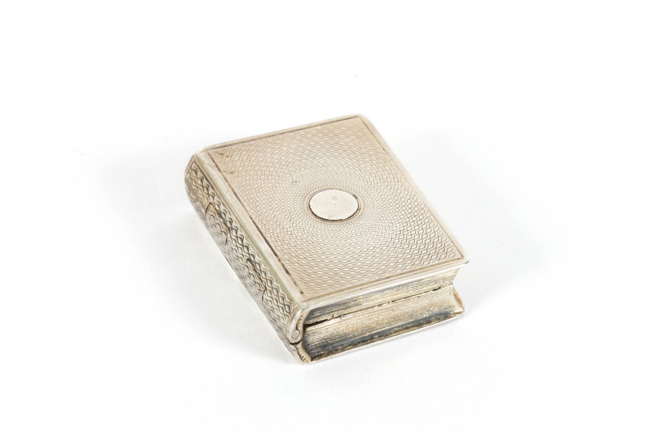 A silver vinaigrette in the form of a book, hallmarked London, 1812, with makers initials, opening