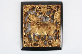 A Chinese gilt wood carved panel of an ox, circa 1920, the gilt wood figure of an ox surrounded by