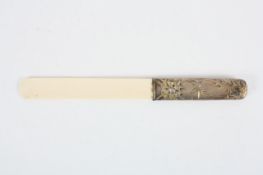 A late 19th century/early 20th century ivory page turner, the handle with silver coloured metal