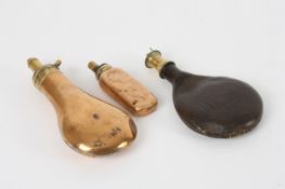 Three 19th century powder flasks, including a leather and brass example with hunting scene to