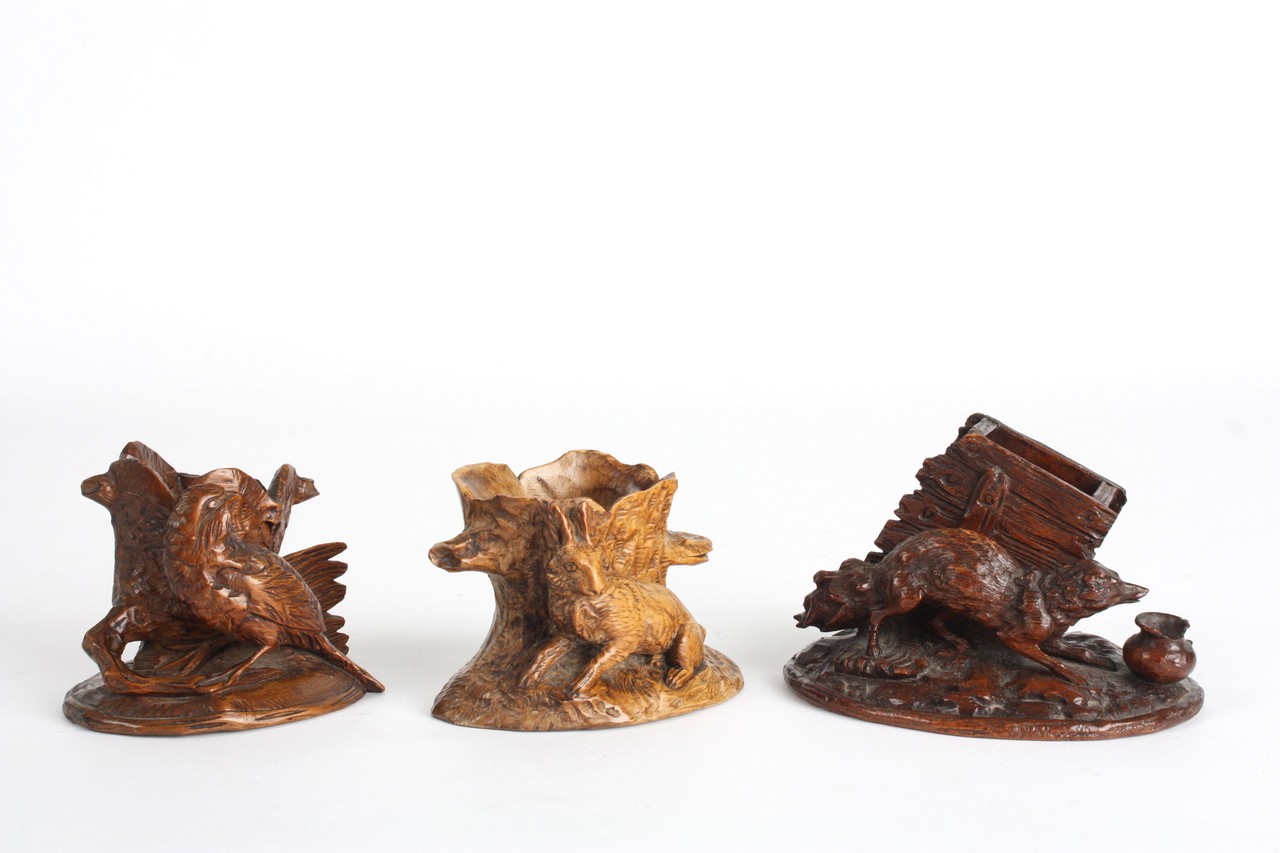 A small collection of 19th century treen, comprising a match holder with fox base, a candle holder