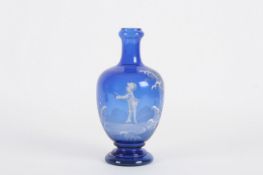 A 19th century Mary Gregory blue glass vase, the baluster shaped vase with white enamel decoration
