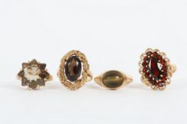 Four 9ct gold dress rings, one mounted with tigers eye, one mounted with an oval garnet, one mounted