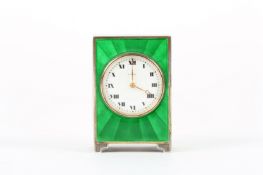 A 1920s Asprey guilloché enamel miniature bedroom clock, the bright green enamel and white metal