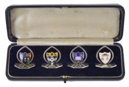 An interesting set of four silver and enamel menu holders with Oxford University Crests,