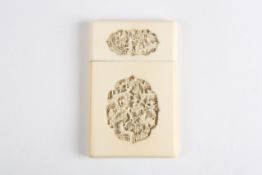 A Cantonese carved ivory card case, late 19th century, carved on both sides with two shaped