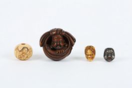 A Japanese netsuke of a Buddha, late 19th/early 20th century, the carved wooden netsuke with