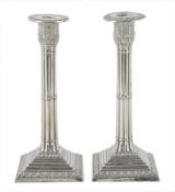 A pair of Edwardian silver candlesticks, hallmarked London, 1901, with acanthus leaf design to the