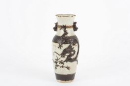 A Japanese early 20th century vase, with high relief moulding of a ferocious dragon, with cream