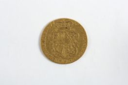 A George II gold guinea, dated 1753, with milled edge. 8 grams Some wear.