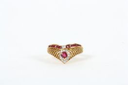 An 18ct gold ruby and diamond ring, the wishbone shaped ring with centre ruby in claw setting
