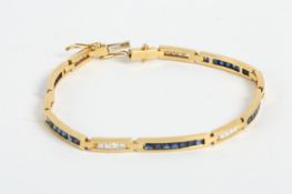 A yellow coloured metal diamond and sapphire bracelet, the bracelet with eleven interconnecting