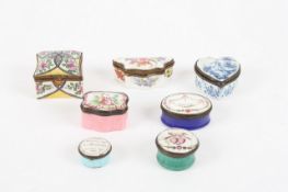 A mixed collection of enamel and porcelain patch boxes, including a pink enamel box decorated with a