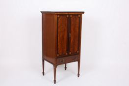 An Edwardian mahogany inlaid cabinet, with a pair of panel doors and supported on square tapering