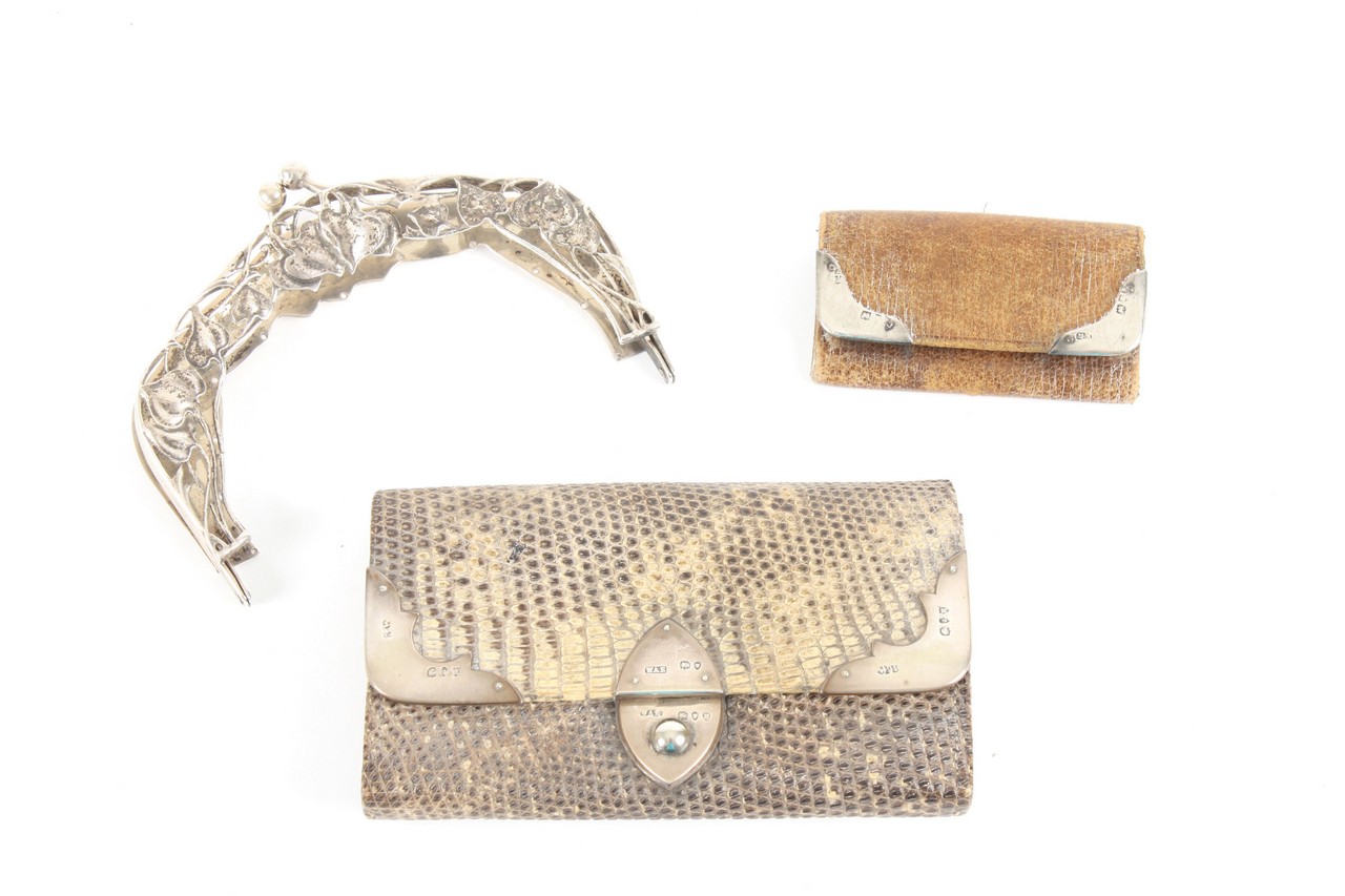 Two leather and silver mounted purses, probably 1920s, the first of lizard leather with silver