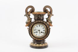 A Continental Majolica clock  possibly Austrian, late 19th century with dophinesque loop handles,