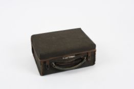 A small leather covered ladies travelling vanity case circa 1907 the green silk lined interior