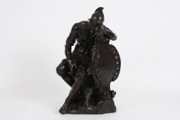 A rare 17th century carved elm figure of a Roman soldier in a seated pose, his arm resting on a