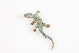 A Continental silver gilt and turquoise lizard brooch realistically modelled and studded with