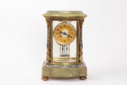 A French late 19th/early 20th century champleve enamel onyx and gilt metal mantle clock with bowed