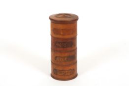 A 19th century treen spice tower of four sections, one section labelled `Nut-meg`, two with