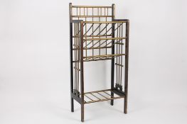 A Victorian aesthetic movement music shelf?of ebonised and brass mounted wooden construction with