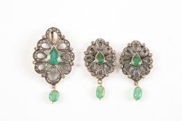 An emerald and diamond suite of jewellery comprising a lozenged shaped pendant and a similar pair of