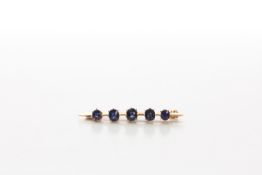 A gold and sapphire five stone bar brooch early to mid 20th century, set with central sapphire of