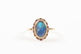 A 9ct yellow gold and backed opal ring of oval form with in a ballerina mount, with part of the