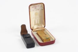 A mid 20th century Dunhill gold plated cigarette lighter with engraved initials, in leather