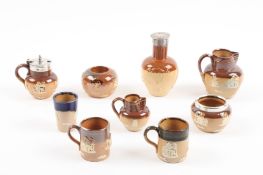 A collection of nine Doulton Lambeth stoneware saltglaze miniatures comprising: two jugs, three