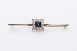 An Art Deco sapphire and diamond bar brooch The large central asscher cut sapphire surrounded by