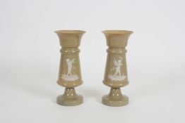A pair of 19th century French opaque glass and enamel vases decorated with Pâte-sur-pâte style