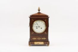 A late 19th century mahogany and brass inlaid mantle clock retailed by Dent of London the flame