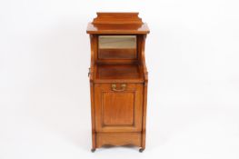 An Edwardian mahogany perdonium?with satinwood crossbanded decoration, the shelf top with mirrored