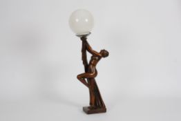 An Art Deco bronzed plaster lamp of a nude woman the girl stood on one leg with the other raised and