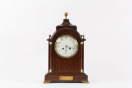 An Edwardian mahogany cased mantle clock the 5-inch dial with Arabic numerals, flanked by columns