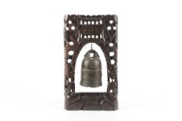 A late 19th / early 20th century Chinese bronze temple bell suspended from a carved hardwood