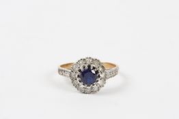 A sapphire and white sapphire cluster ring with central sapphire, surrounded by white sapphires,