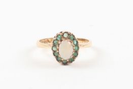 A 9ct yellow gold, opal and emerald oval cluster ring. hallmarked Birmingham 1975. 2.1 grams. Good