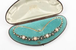 An Edwardian coral, pearl, diamond choker necklace formed as four alternating roundels of coral