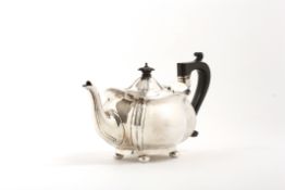 A George V silver teapot hallmarked Birmingham 1925, the body of bombe shape, with ebonised handle