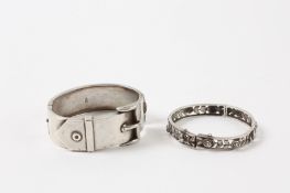 A Victorian silver bangle in the form of a buckle hallmarked 1885 and a child`s white metal bangle