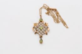 An Edwardian 9ct gold, seed pearl and peridot pendant of lozenge shape, set with three peridots,