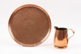 A Newlyn Arts & Crafts hammered copper circular tray stamped Newlyn, with rolled rim and central